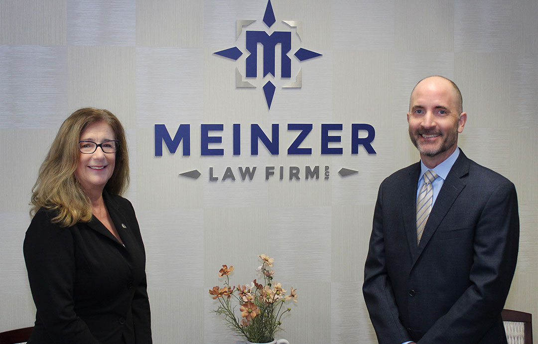 man and woman standing in front of sign