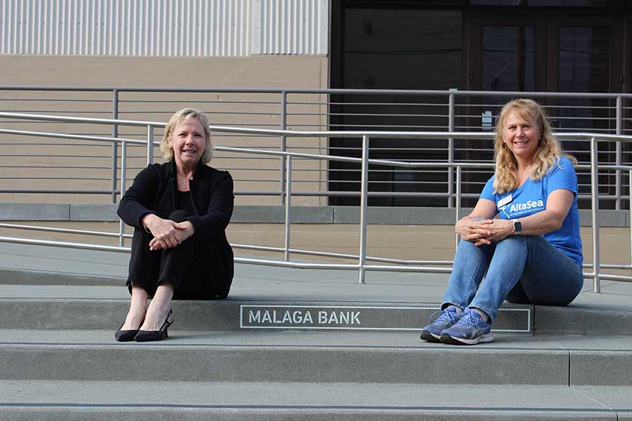 2 women sitting on concrete steps