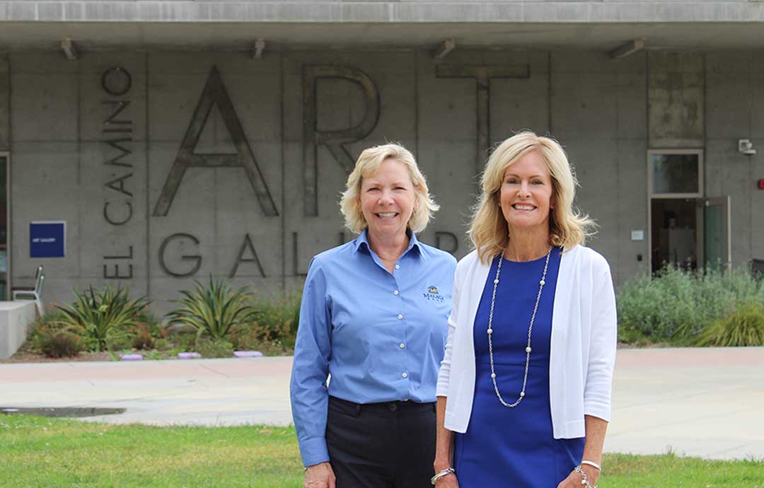 2 women standing in front of Art Department building