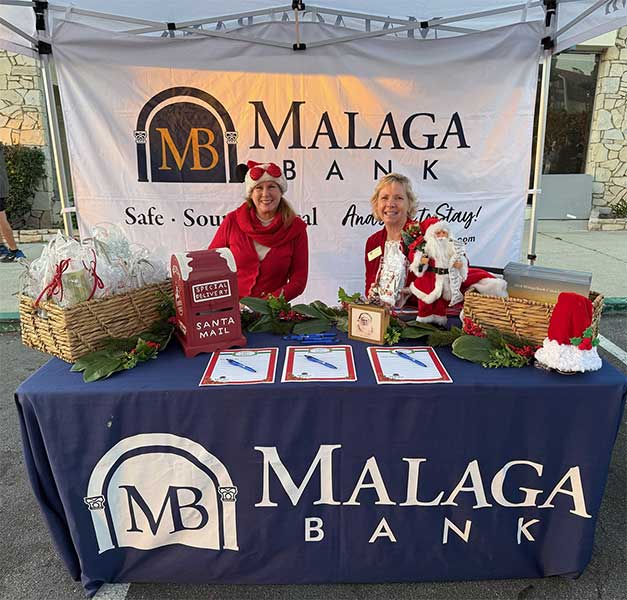 Two women sitting at a table for christmas event