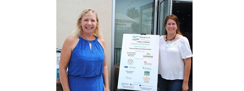 2 women attending caring house event