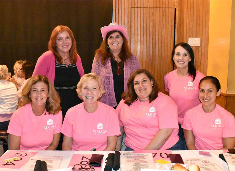 four women in pink shirts