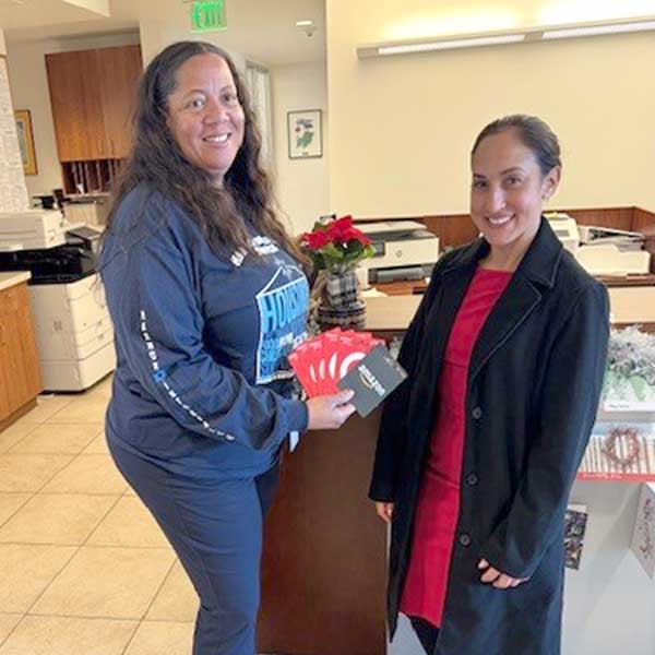 2 woment holding gift cards