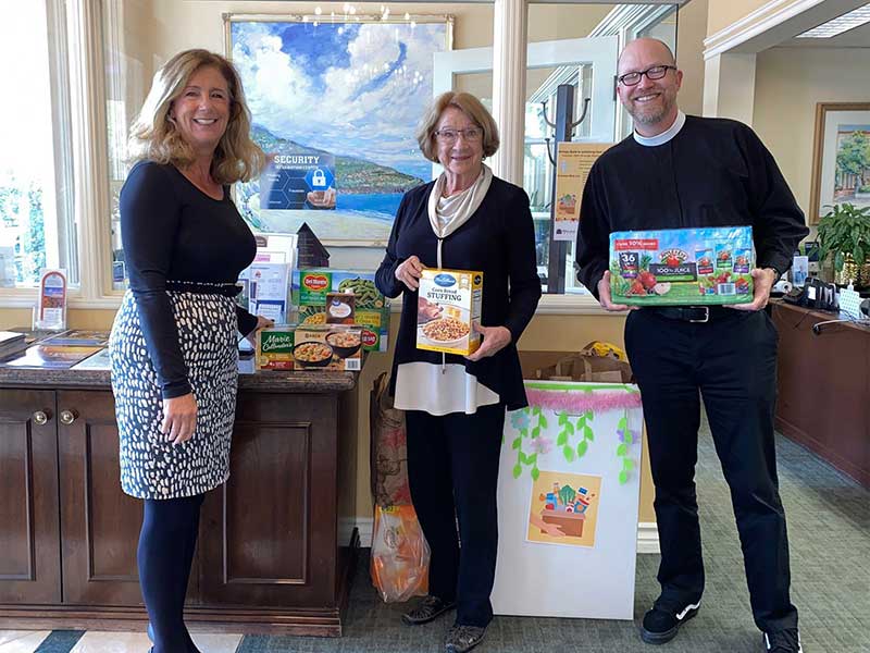 2 women and 1 man discussing food donations