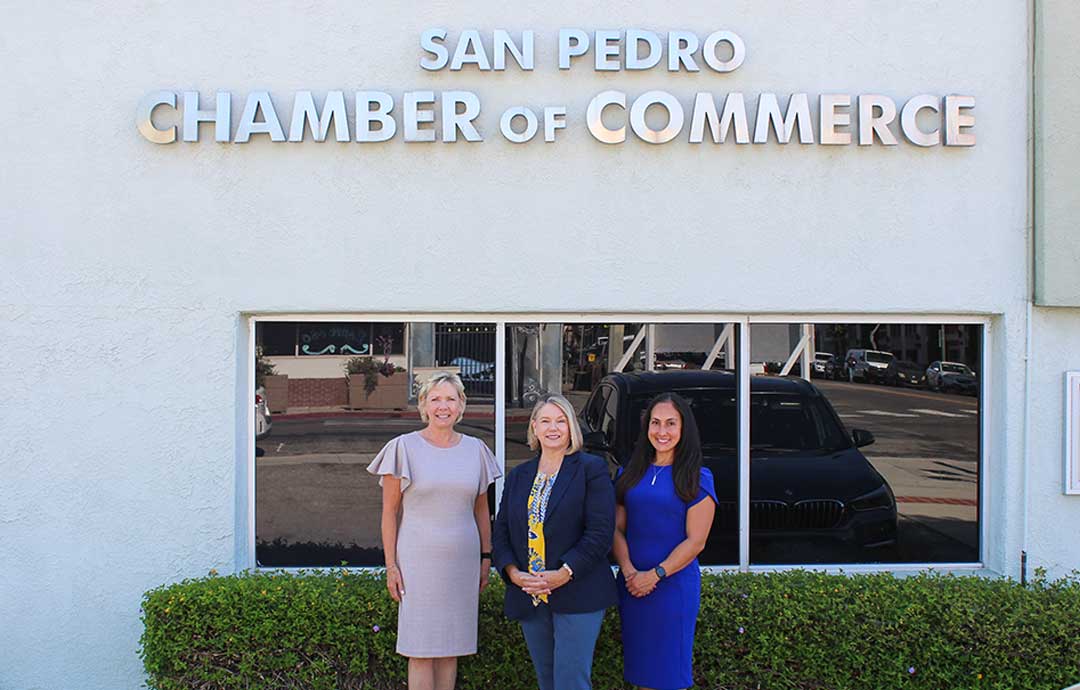3 women standing in front of building