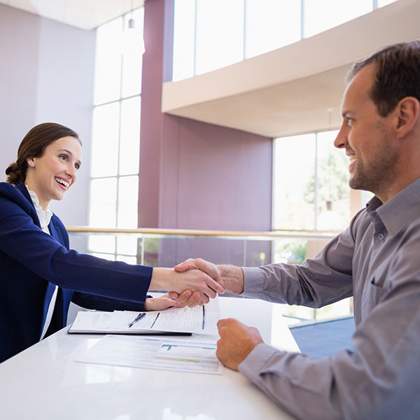 Woman shaking a man's hand.