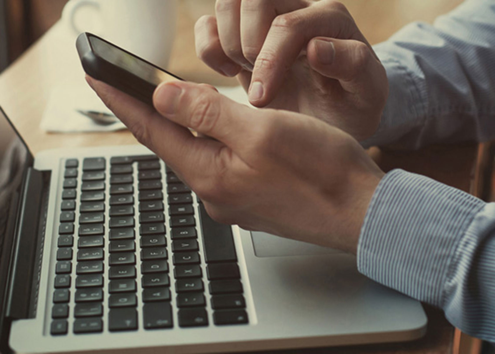 Man holding a cell phone to access the internet. 