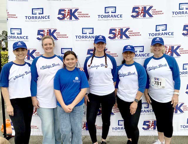 group standing in front of 5k backdrop
