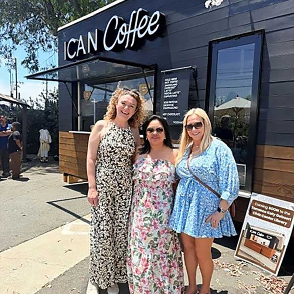 3 women standing in front of iCan Coffee
